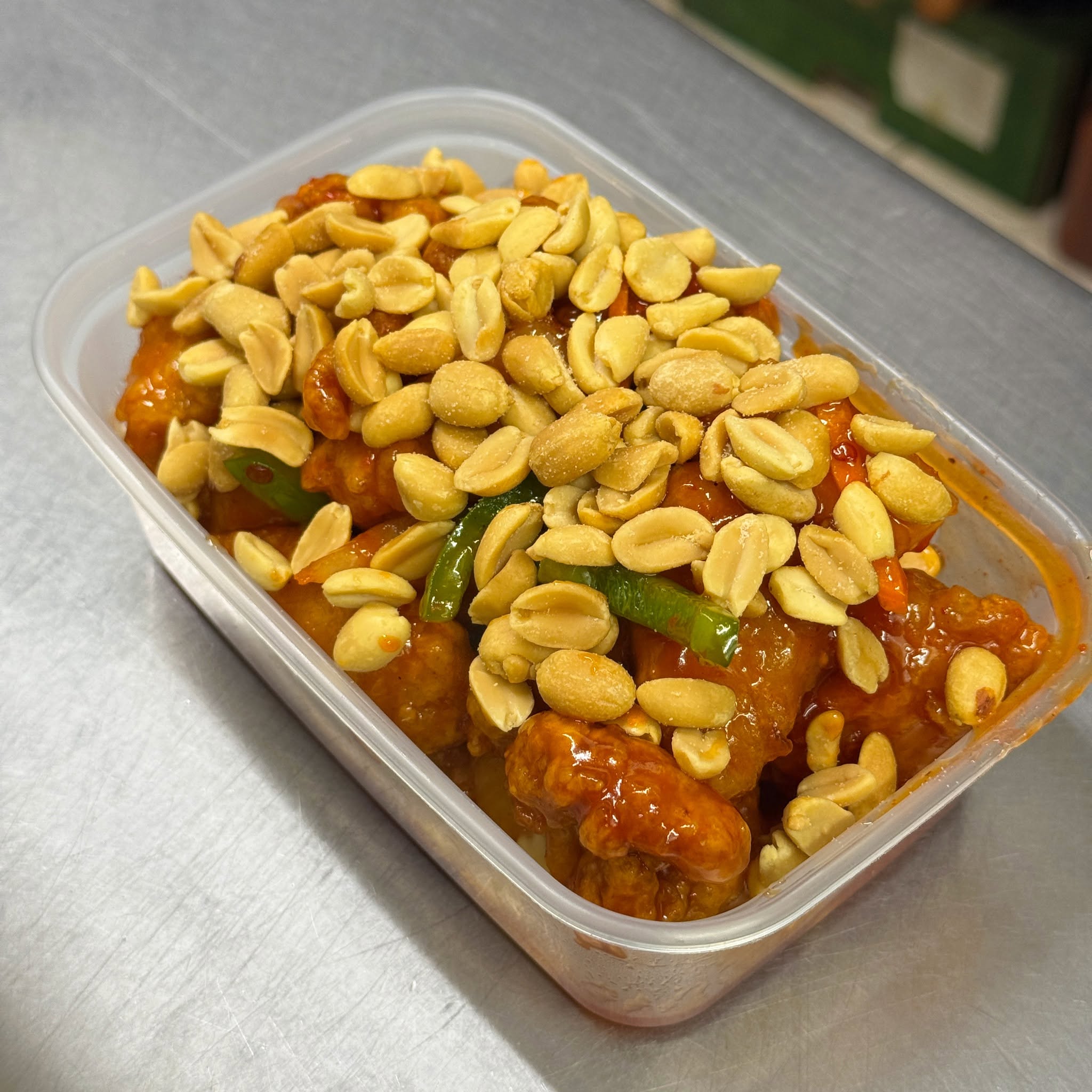 Crispy Kung Po chicken topped with crunchy peanuts