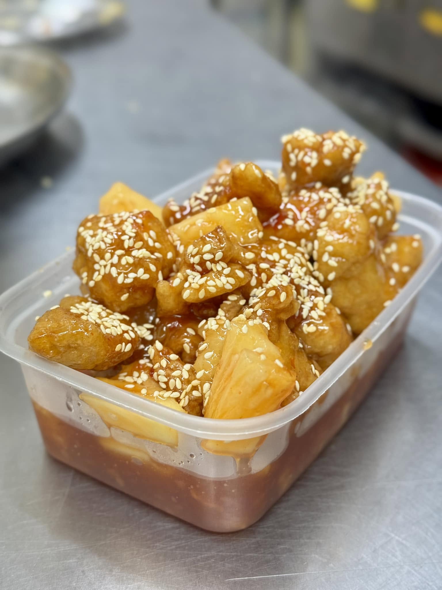 Sesame chicken fillets coated in a glossy sauce