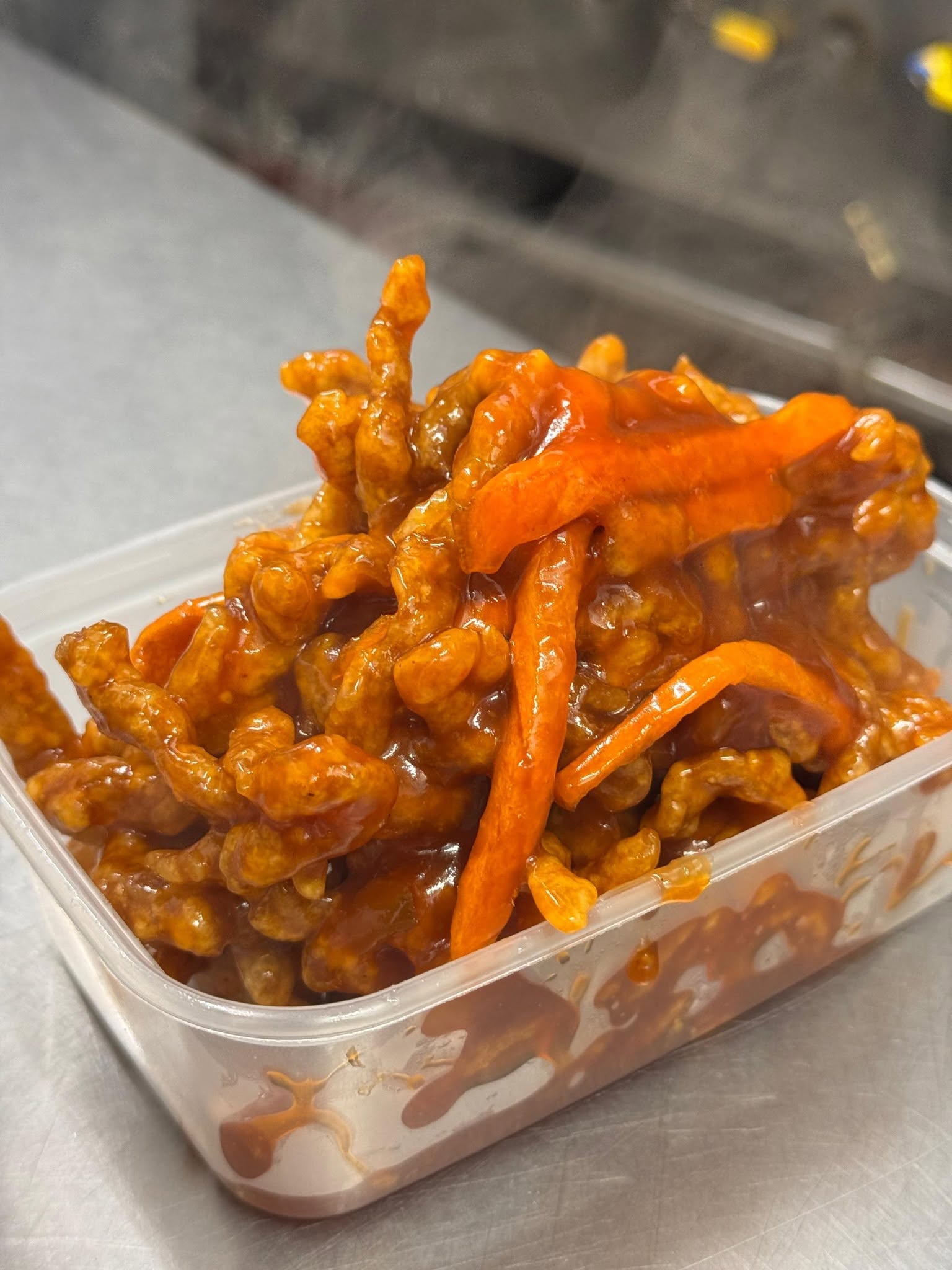 Deep fried shredded beef in a glossy sauce